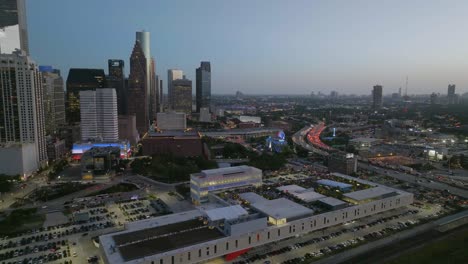 Aerial-view-around-the-POST-Houston-Cultural-center,-dusk-in-Texas,-USA---orbit,-drone-shot