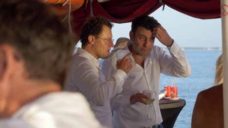 Guys-talk-on-a-catamaran-boat-in-the-Mediterranean