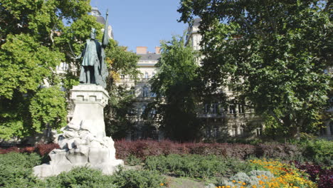 Prominent-statue-stands-within-well-manicured-garden-in-Budapest,-Hungary