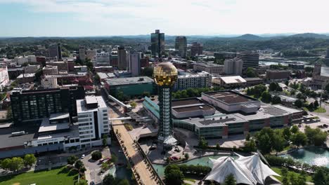 Aerial-view-around-the-Sunsphere-tower-and-downtown-Knoxville,-sunny-Tennessee,-USA