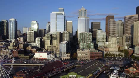 Aerial-view-close-to-the-Central-Waterfront,-revealing-the-Seattle-Great-Wheel,-afternoon-in-Nortwest-USA