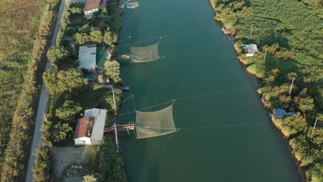 Aerial-view-of-fishing-huts-in-the-river,-Lido-di-Dante,-Fiumi-Uniti,-Ravenna-near-Comacchio-valley