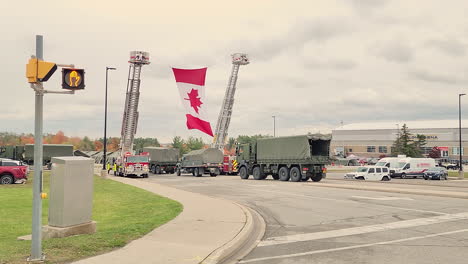 Canadian-Flag-Raised-By-Two-Fire-Engines-During-Funeral-Procession-For-Two-Police-Officers-Killed-In-Innisfil