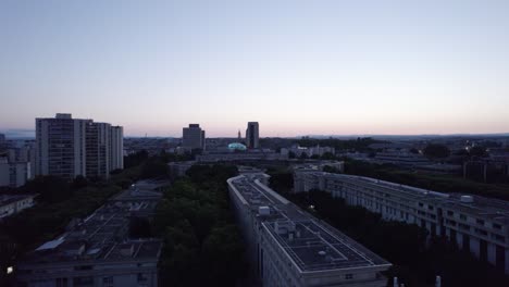 Montpellier-rooftops-at-dusk-ascending-aerial-shot-above-the-cityscape