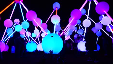 People-in-darkness-interact-with-illuminated-Affinity-neuron-artwork,-Chavasse-park,-Liverpool-River-of-light