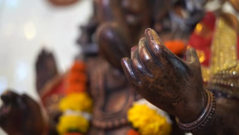 ganpati-statue-of-Indian-god-dark-stone-closeup-of-hand
