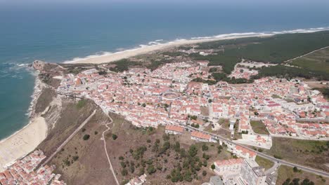Nazare-old-town-on-promontory-and-coastline-in-background,-Portugal