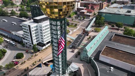 Aerial-view-around-the-independence-day-flag-on-the-Sunsphere-tower-in-Knoxville,-USA---circling,-drone-shot