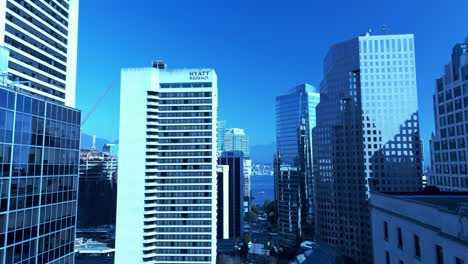 Vancouver-downtown-drone-aerial-Burrard-street-post-COVID-global-warming-sunny-hot-day-in-October-with-light-traffic-during-rush-hour-between-Robson-and-Melville-harbor-tour-boats-green-trees-3-5
