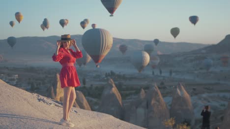 Attractive-woman-in-dress-posing-with-hot-air-balloons-Cappadocia