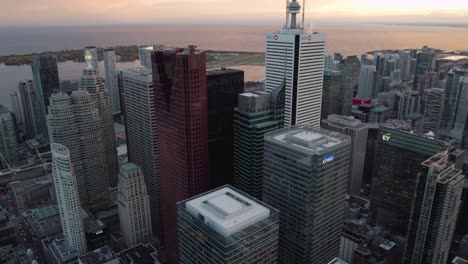 Aerial-view-towards-skyscrapers-in-downtown-Toronto,-sunset-in-Canada---tilt,-drone-shot