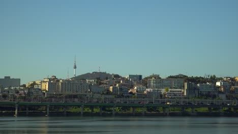 The-Yongsan-District-of-Seoul,-South-Korea-and-the-historic-Namsan-Tower-on-a-clear-day-over-the-Han-River