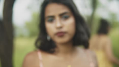 A-blurred-shot-of-the-face-of-an-attractive-Asian-female-in-a-natural-forest-environment,-the-young-carefree-lady-disappointed-and-turns-around-and-walks-away,-India