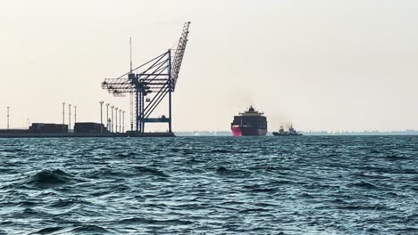 Cargo-Ship-With-Tugboat-Docked-At-Harbour-In-Odesa,-Ukraine-From-A-Boat