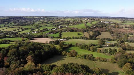 Aerial-shot-with-a-view-of-a-village-and-the-beautiful-East-Devon-Countryside-in-England