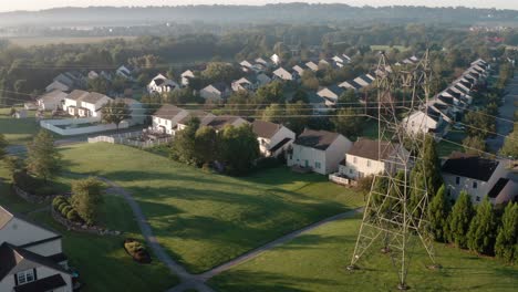 Aerial-of-power-electricity-wire-lines-beside-neighborhood-homes-in-USA