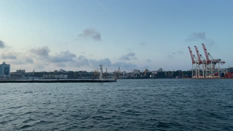 Harbour-Cranes-At-Port-Of-Odesa-From-A-Boat-Crossing-At-Calm-Waves-Of-Black-Sea-In-Ukraine