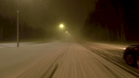 POV-overtaking-shot-on-a-snow-covered-Helsinki-highway-at-night