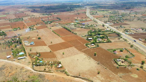 Jib-down-of-a-beautiful-landscape-with-farms-in-rural-Kenya,-Africa