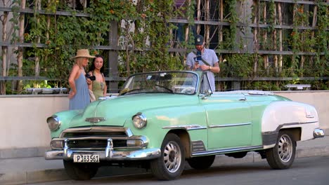 Classic,-vintage,-convertible-car-is-admired-on-the-streets-of-Havana,-Cuba