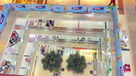 Looking-Down-At-Shopping-Mall-Floors-With-Shoppers-Walking-Past-In-Dhaka