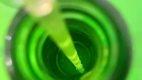 Macro-Shot-Of-Straw-In-Green-Bottle