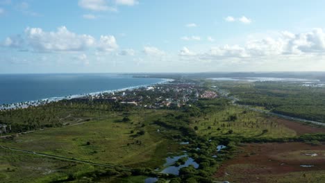 Tilt-up-aerial-drone-shot-revealing-the-beautiful-tropical-coastline-of-the-famous-tourist-beach-of-Porto-de-Galinhas-or-Chicken-Port-in-Pernambuco,-Brazil-on-a-warm-sunny-summer-day