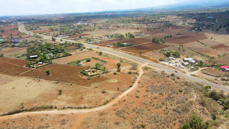 Jib-down-of-a-beautiful-African-landscape-with-distant-farms-and-buildings