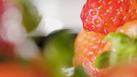 Water-drops-falling-over-Strawberry,-Organic-fruit-concept,-Extreme-Closeup-shot