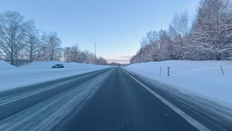 Timelapse-POV-shot-driving-along-a-snow-covered-Helsinki-Highway