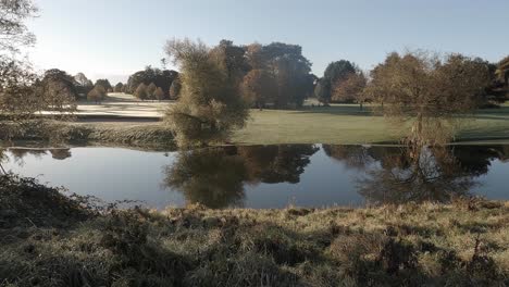 Calm-pond-reflects-frosty-Waterford-Golf-Resort-on-cool-sunny-morning