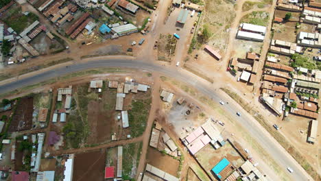 Top-down-aerial-of-a-calm-road-running-through-a-small-town-in-Kenya