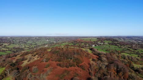 Aerial-shot-of-Dumpdon-Hill-in-Devon-England-on-a-sunny-day-with-the-beautiful-English-countryside-in-the-distance