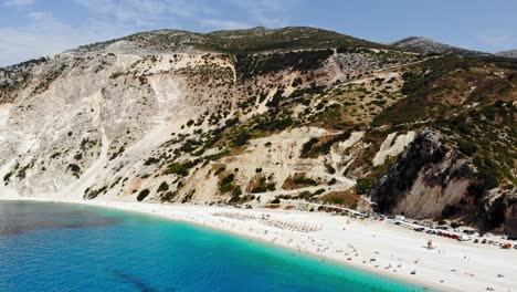 Scenic-View-Of-Myrtos-Beach-With-Mountains,-White-Sand,-And-Calm-Turquoise-Water---aerial-drone-shot
