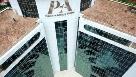 Exterior-Of-Pearl-of-Africa-Hotel-In-Kampala,-Uganda---drone-descending