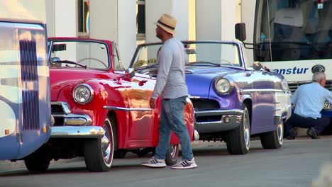 Classic,-restored,-vintage-cars-parked-along-the-road-in-Havana,-Cuba
