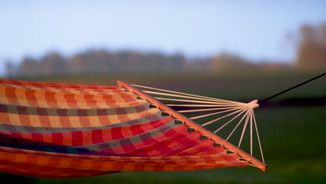 Empty-sleeping-net-hammock-between-trees-swinging-in-calm-wind