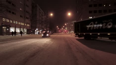 POV-shot-driving-through-downtown-Helsinki-with-snow-piled-high