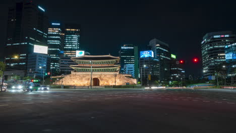 Sungnyemun-gate-or-Namdaemun-gate-Night-traffic-time-lapse-in-crossroads-with-modern-skyscraper-buildings