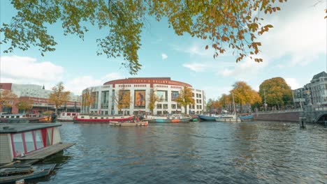 Ultra-Wide-angle-4K-Time-Lapse-view-of-Opera-house-Amsterdam,-Netherlands-on-bright-sunny-autumn-day