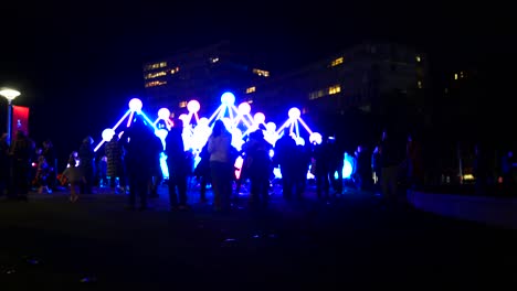 People-interact-with-illuminated-Affinity-neuron-artwork,-Chavasse-park,-Liverpool-One-River-of-light