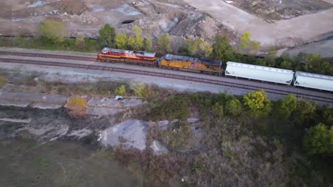 Aerial-view-around-a-cargo-train,-sunny-morning-in-Houston,-Texas-USA---circling,-drone-shot