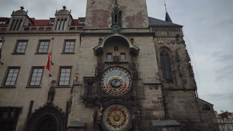Orloj-Astronomical-Clock-on-Hall-building-in-Old-Town-Square-Prague,-tilt-up-low-angle-view,-no-people
