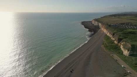 Newhaven-shore-line-with-sun-and-cliffs-,-pebbles-beach