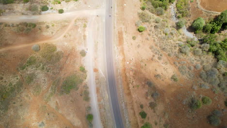 Top-down-view-of-traffic-driving-over-road-in-rural-Kenya