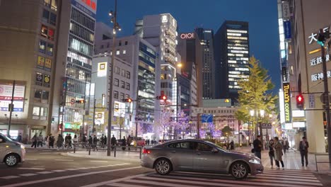 Downtown-Osaka-in-Winter,-Streets-Illuminated-and-City-in-Background