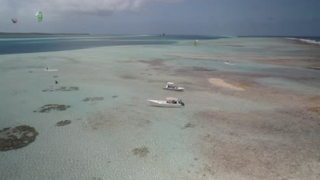 Aerial-view-motorboat-with-people-kite-safari,-east-reef-barrier-Sebastopol-Los-Roques