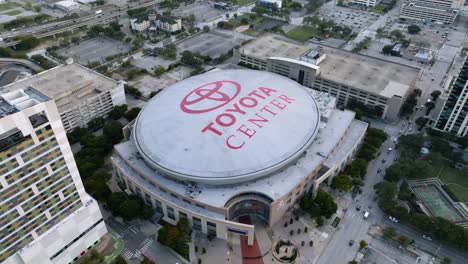 Aerial-view-around-the-Toyota-center,-in-sunny-Houston,-Texas,-USA---high-angle,-orbit,-drone-shot