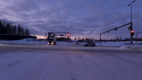 POV-static-shot-sitting-at-traffic-lights-with-other-cars-driving-in-Helsinki