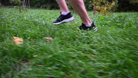 side-view-of-a-runner-and-his-shoes:-endurance-training-on-grass,-in-the-nature